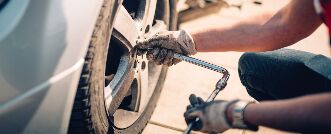 Mechanic working on a tire while wearing gloves