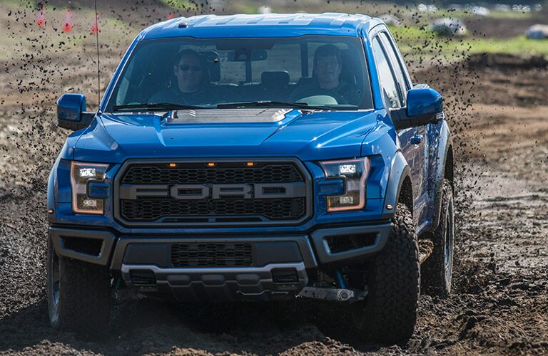 2018 Ford F-150 Raptor blue front view in mud