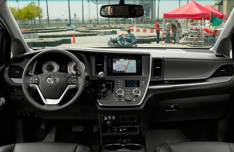 Interior View of the 2017 Toyota Sienna Steering Wheel and Center Dash in Black