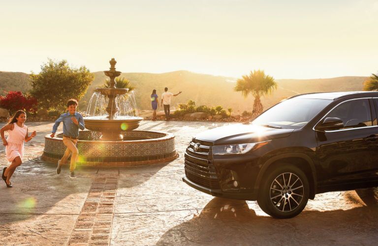 2017 Toyota Highlander Exterior View with Family Standing Around Vehicle