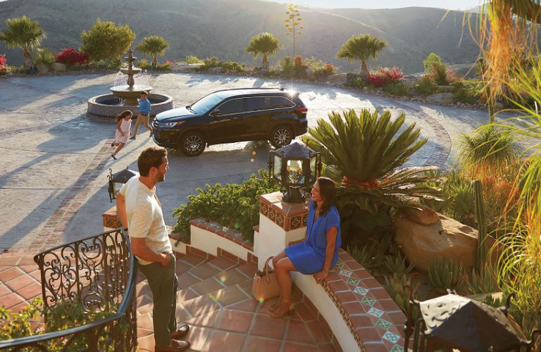Exterior View of the 2017 Toyota Highlander in Black with Family Around it