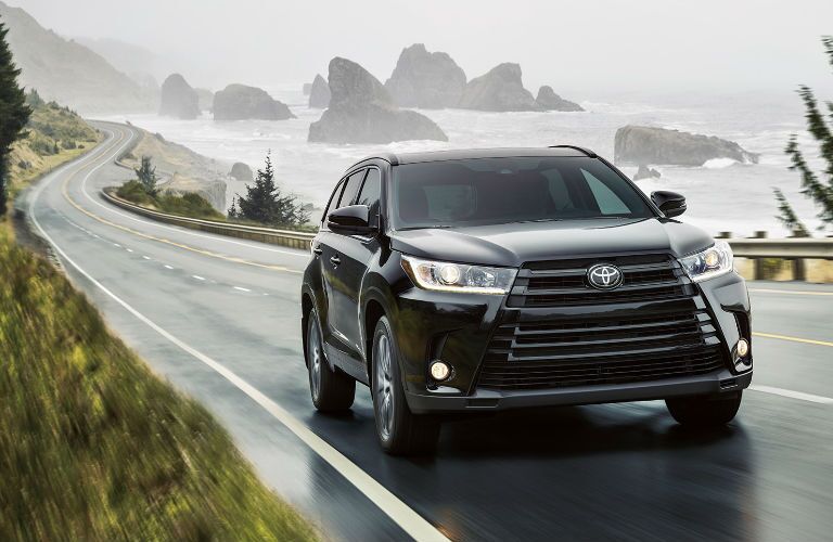 2017 Toyota Highlander Driving by body of Water Exterior View in Black