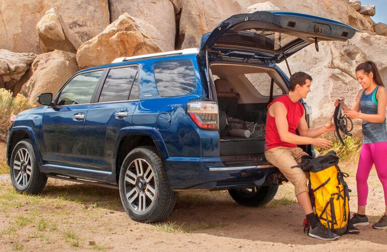 Two people sitting in the cargo bed of the 2019 Toyota 4Runner