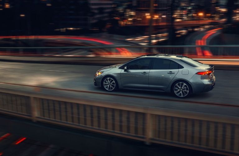 2020 Toyota Corolla crossing an overpass at night