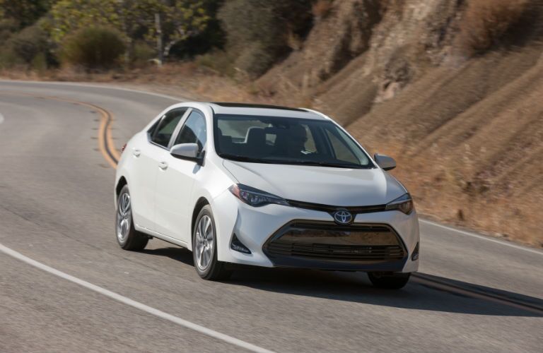 A photo of the certified used pre-owned Toyota Corolla in motion on the road.