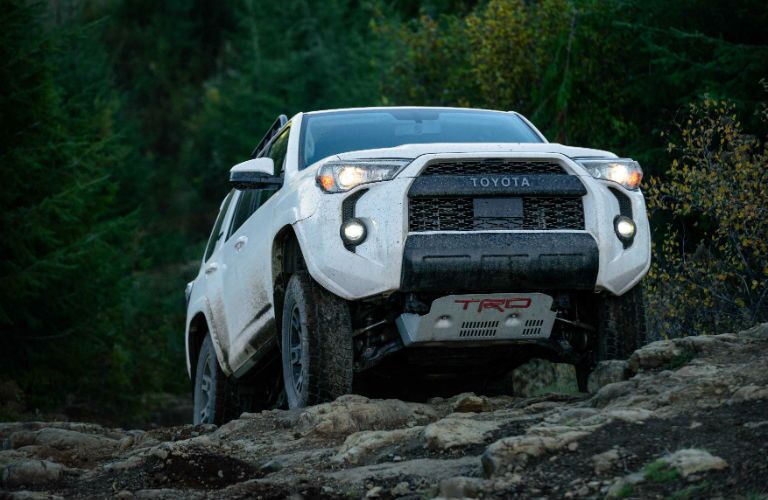 A photo of the 2020 Toyota 4Runner coming over a rock hill.