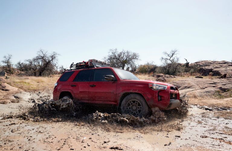 A photo of the 2020 Toyota 4Runner driving through deep mud.