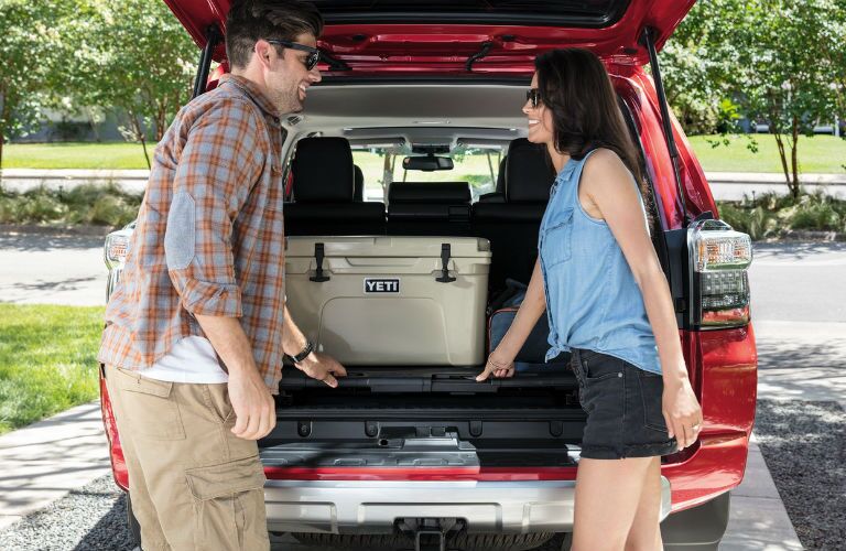 A photo of people unloading cargo from the back of the 2020 Toyota 4Runner.