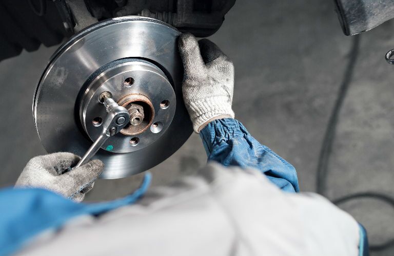 Service Rep Working on Brake