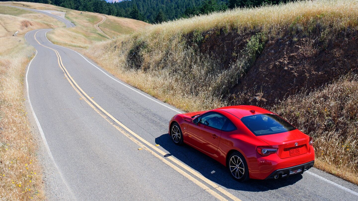 Rear exterior view of a red Toyota 86