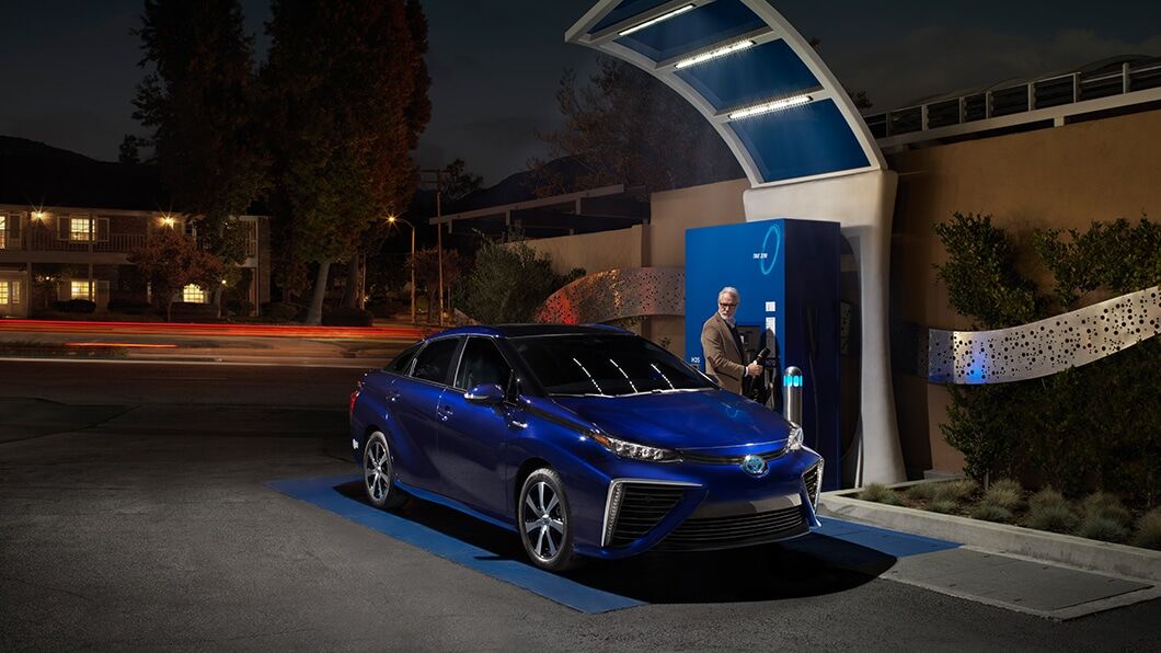 Passenger side exterior view of a blue Toyota Mirai