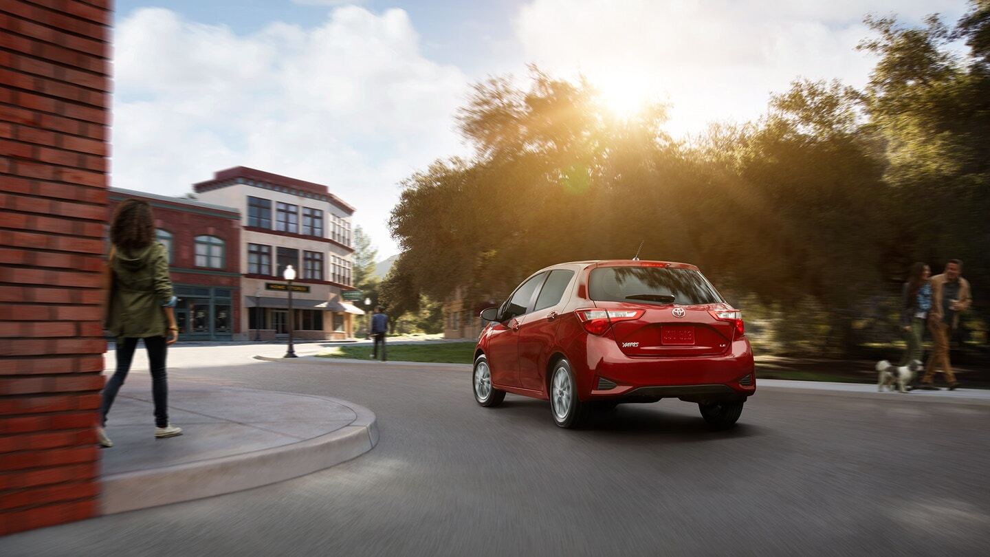 Rear exterior view of a red Toyota Yaris Liftback