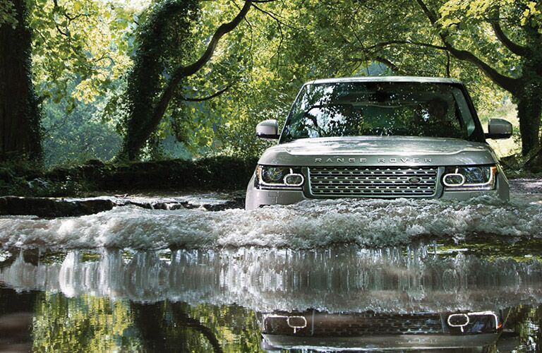 land rover range rover fording a river