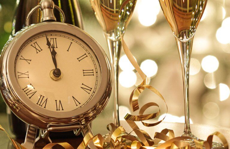 clock and wine glasses with a gold aesthetic