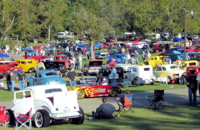 many brightly-colored vehicles at a car show