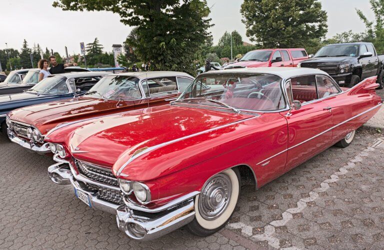 side view of a red classic car at a car show