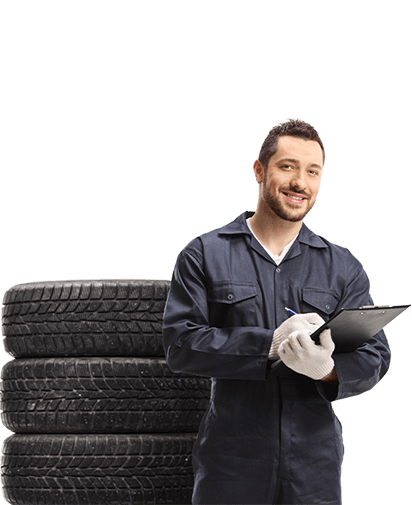 Smiling mechanic with arms crossed holds a wrench.