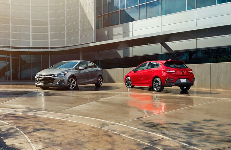 2019 Chevy Cruze silver sedan and red hatchback side by side