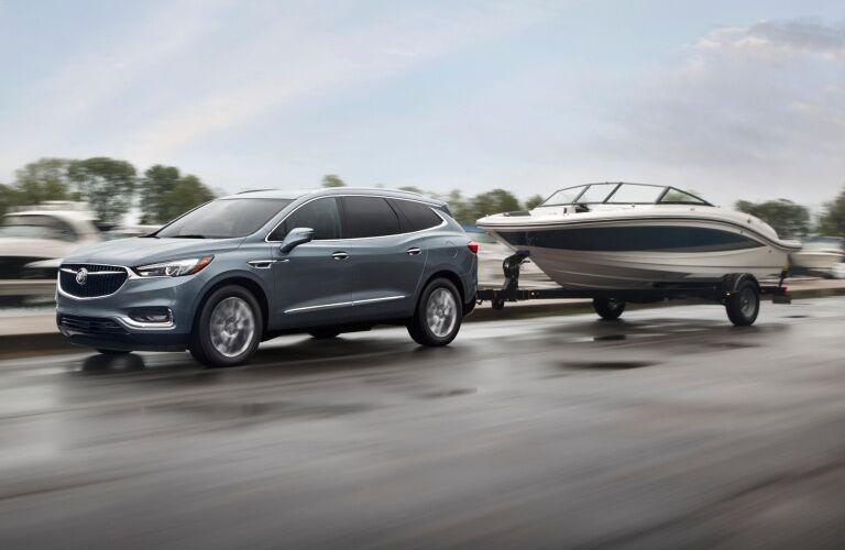 2019 Buick Enclave blue side view towing a boat