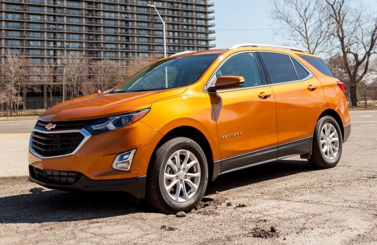 2019 Chevy Equinox orange side view on a beach