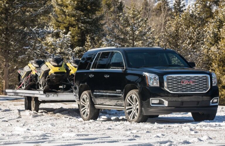2019 GMC Yukon black towing snowmobiles