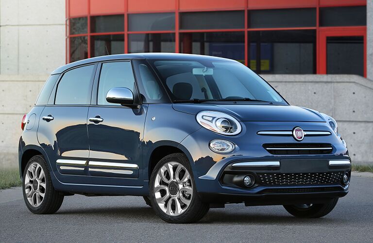 Blue 2018 Fiat 500L parked in front of building