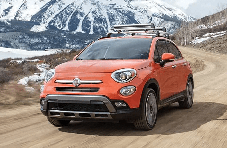 Orange Fiat 500x driving on mountainous road