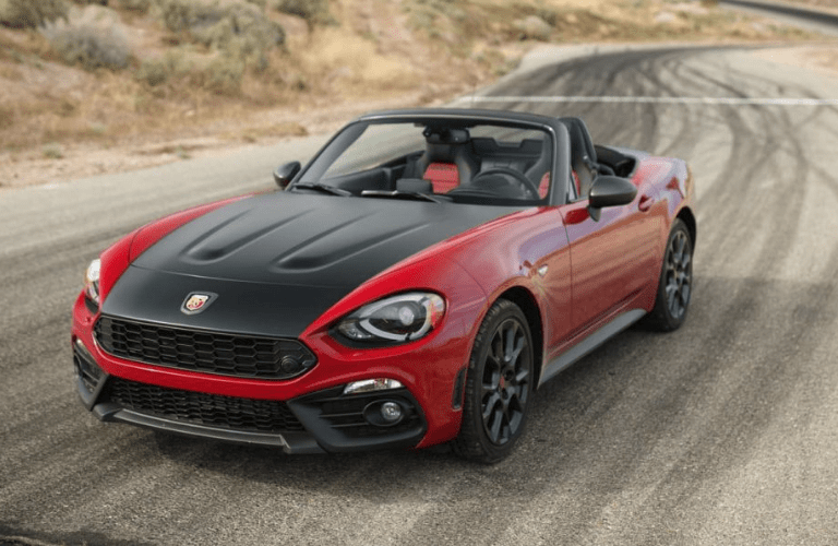 Red 2018 Fiat 124 Spider driving on mountain road