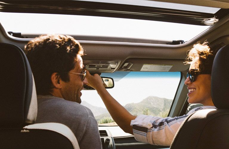 A Couple Sitting in the Front Seats of the 2017 Toyota Camry