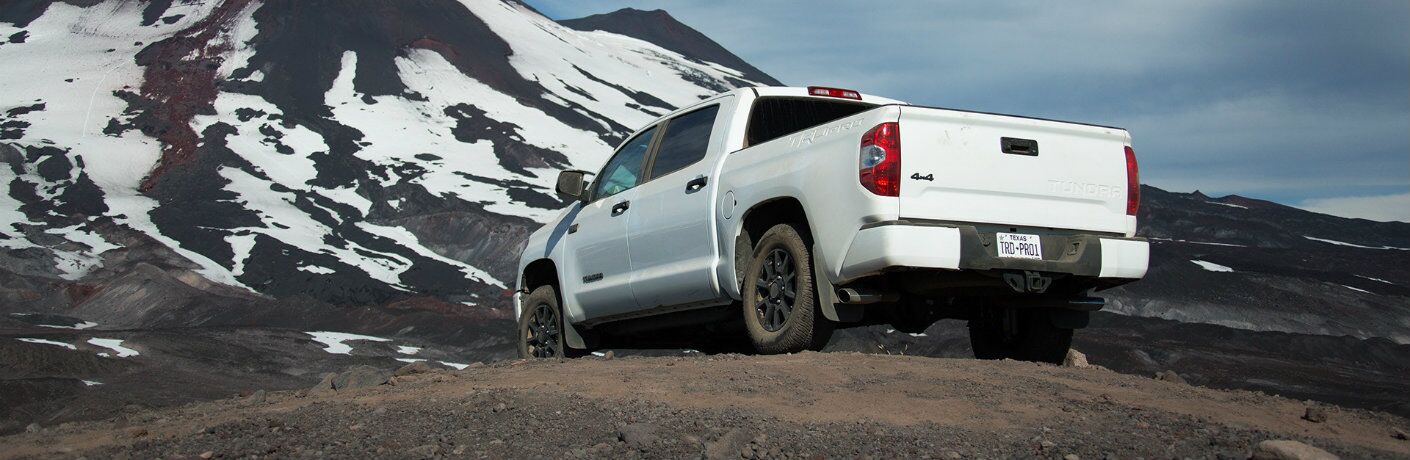 Rear view of white 2019 Toyota Tundra TRD Pro parked and facing mountain