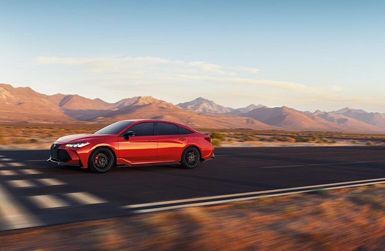 Side view of red 2020 Toyota Avalon driving