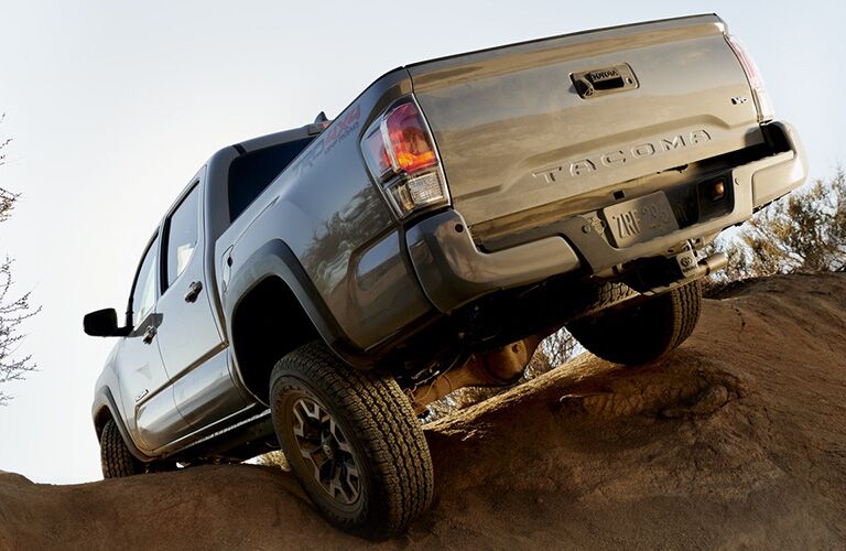 Rear view of 2020 Toyota Tacoma going over dirt