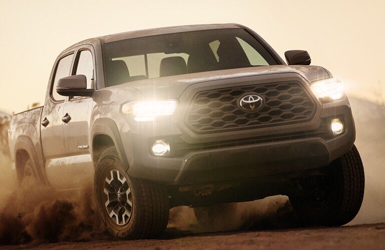 Grey 2020 Toyota Tacoma driving through dirt