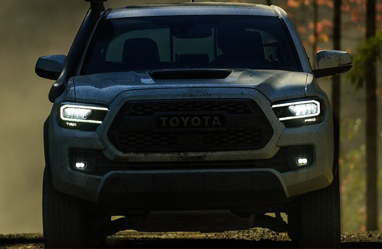 Front view of 2020 Toyota Tacoma with headlights on