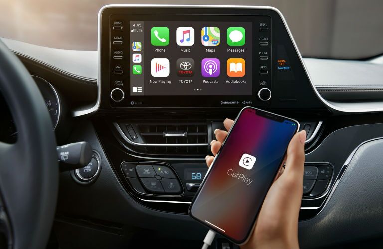 A photo of a person using the infotainment system in the 2020 Toyota C-HR.