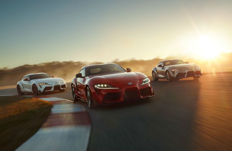 A photo of three 2020 Toyota Supra models on a race track.