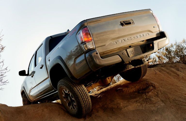 A photo of a 2020 Toyota Tacoma TRD-branded truck cresting a hill.