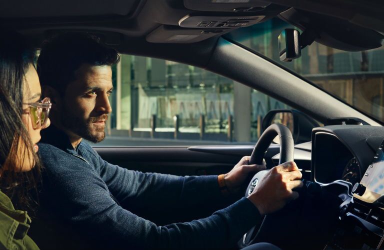 A photo of people sitting in the front seat of the 2020 Toyota Avalon.