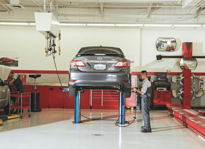 Technitian working on Tires on Vehicle