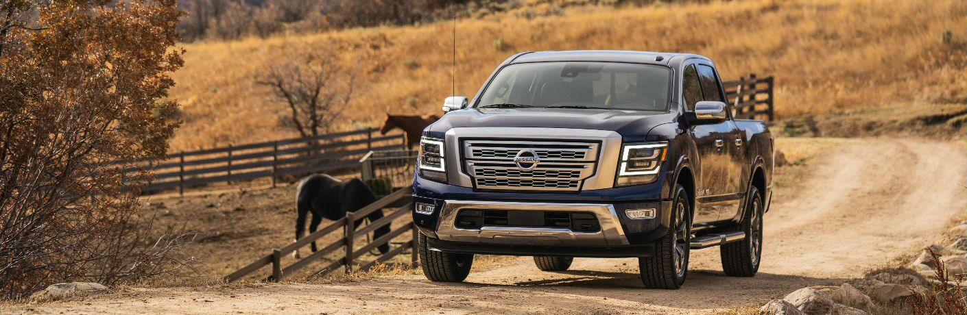 2021 Nissan TITAN drives by a horse