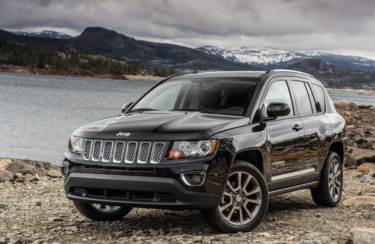 2016 Jeep Compass parked on gravel next to a lake