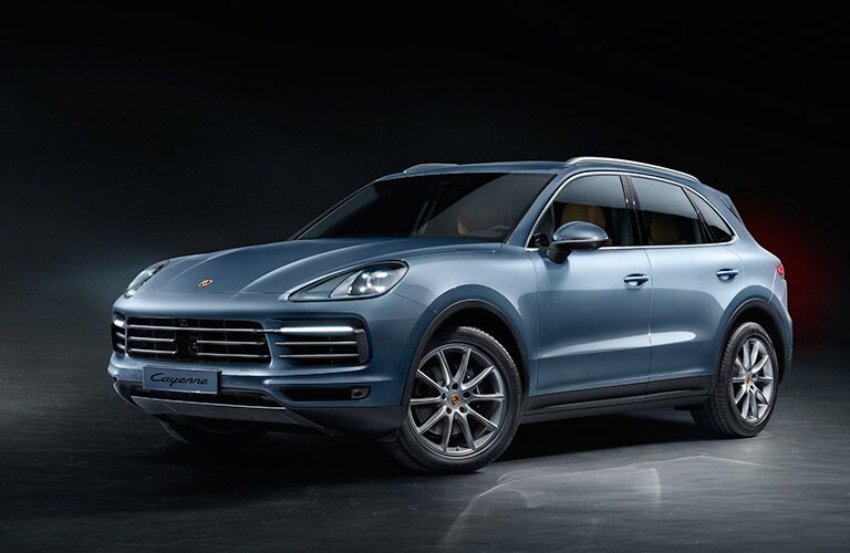2018 Porsche Cayenne in a black showroom