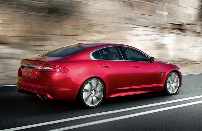 Side profile of a red Jaguar sedan