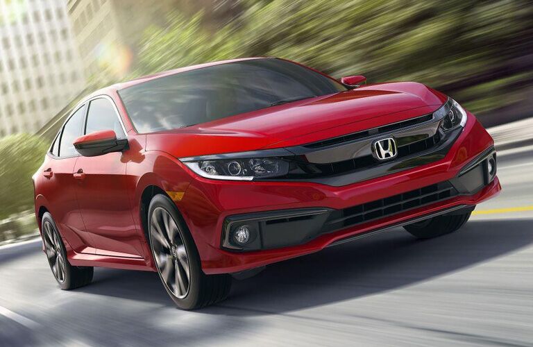 Front passenger side exterior view of a red Honda Civic Sedan