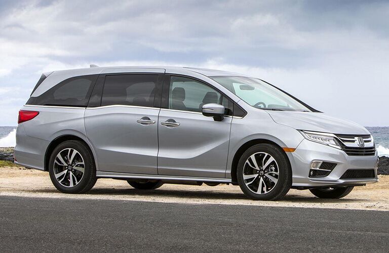 Passenger side exterior view of a gray Honda Odyssey