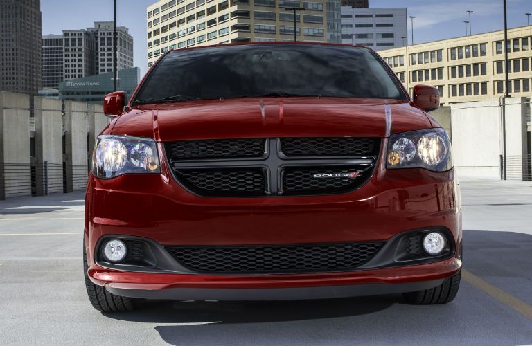 front view of red minivan in the city