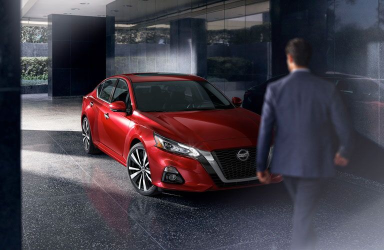 red nissan altima with man