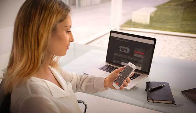 Woman looking at Porsche App in , WI