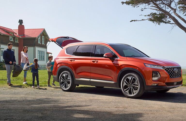 orange 2020 Hyundai Santa Fe with family