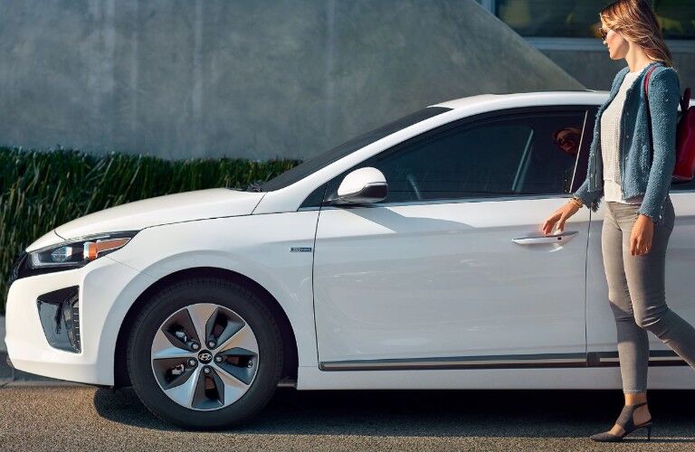 white 2019 Hyundai IONIQ Electric by a woman